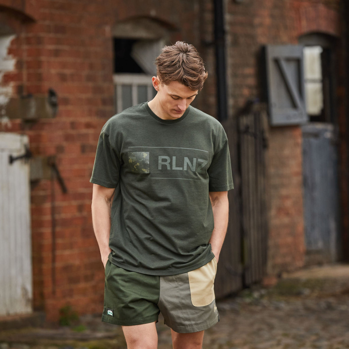 man wearing backslider shorts in olive with a olive t-shirt.