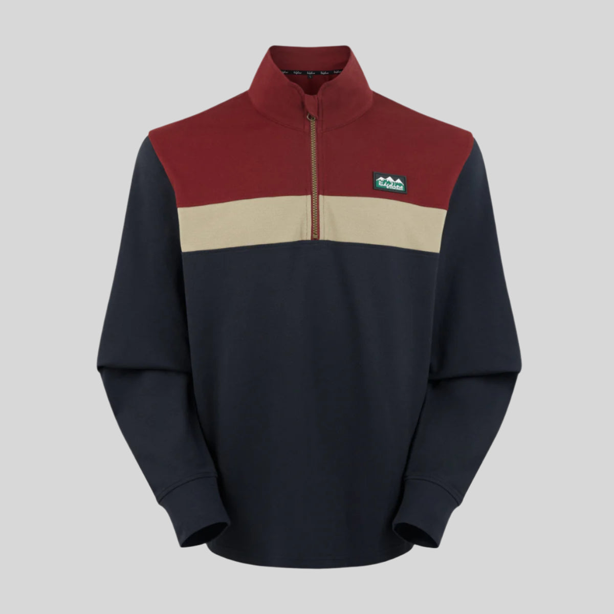 A rugby top with a 1/4 zip front, featuring a colour block design with navy blue, red, and beige colours.