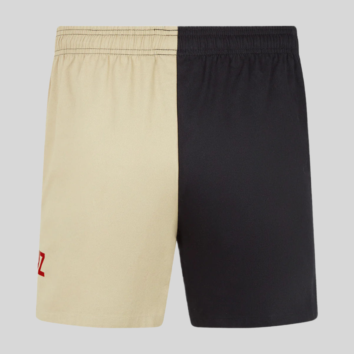 Beige and black shorts with a red logo on a white background