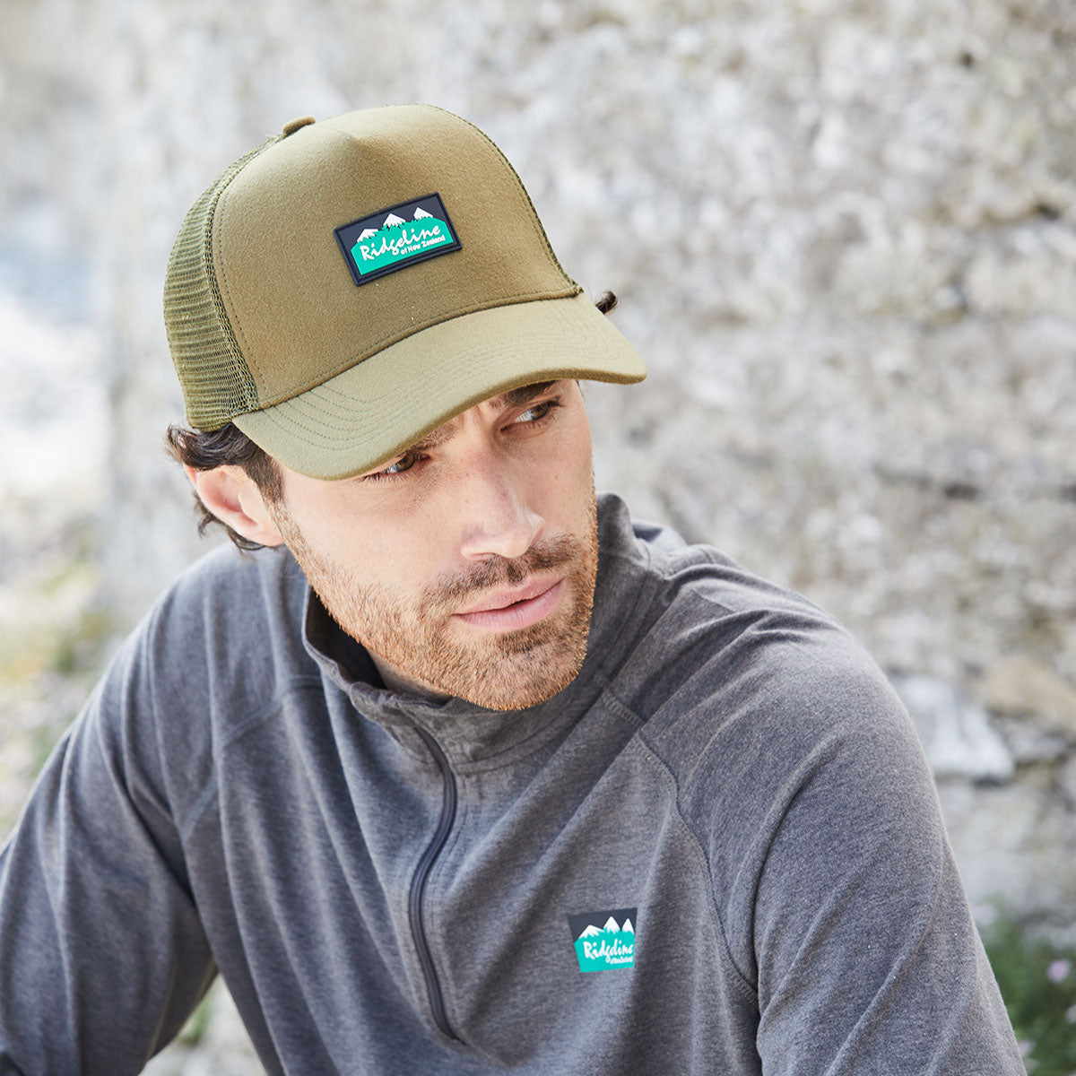 Man wearing a cap and pullover with Ridgeline Clothing logo outdoors