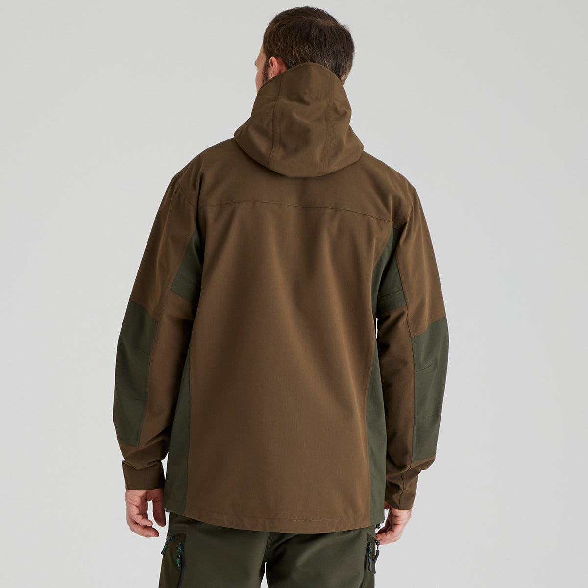back view of person wearing a brown and green jacket on a light grey background