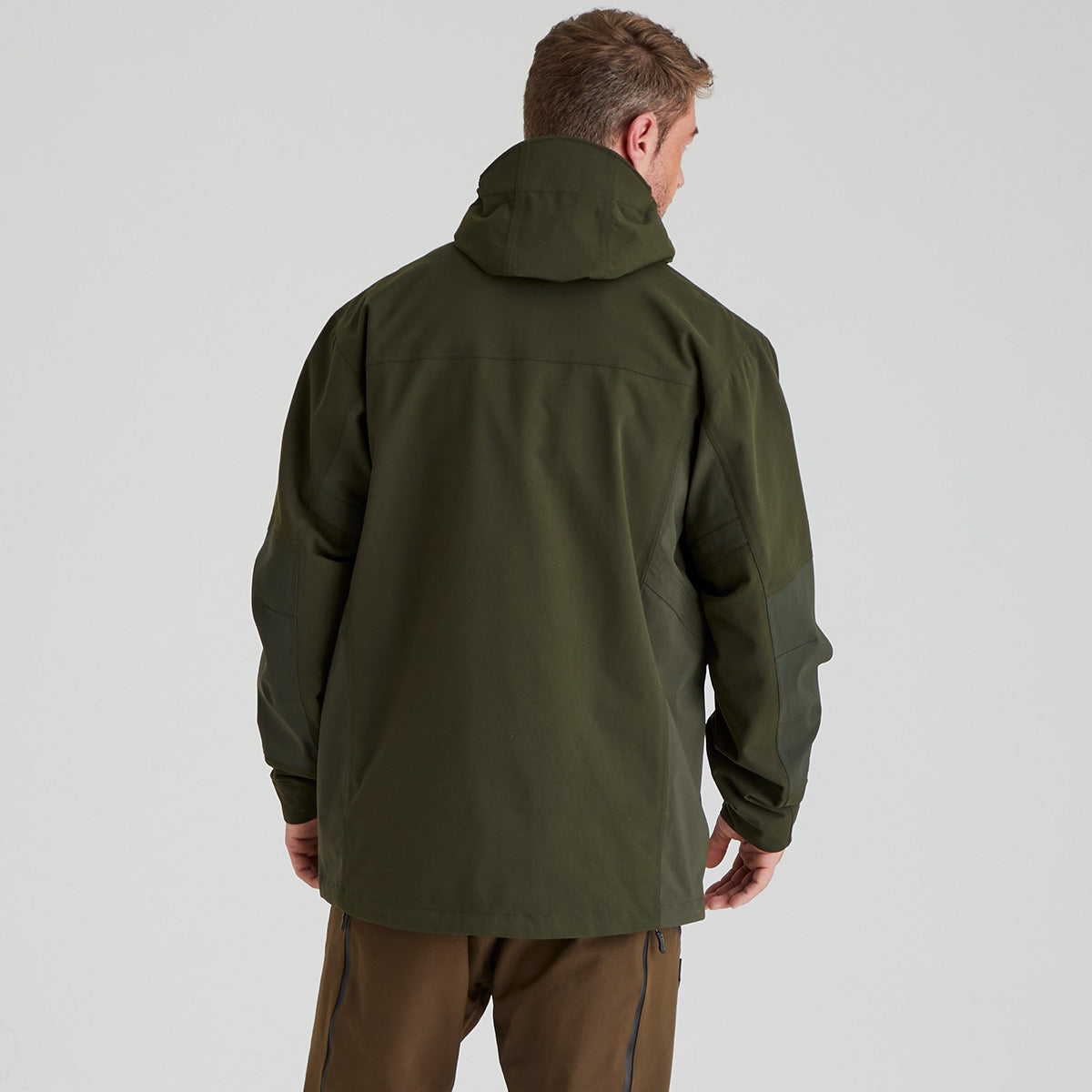 back view of person wearing a green jacket on a light grey background
