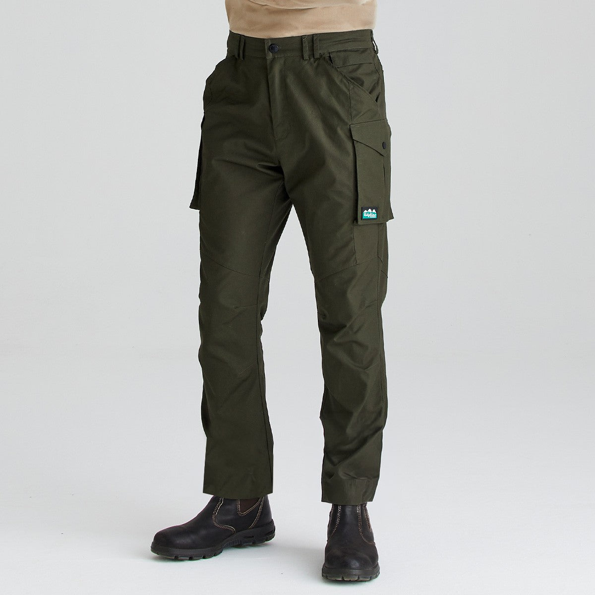 Olive green cargo work trousers with multiple utility pockets, angled front view worn with black work boots.