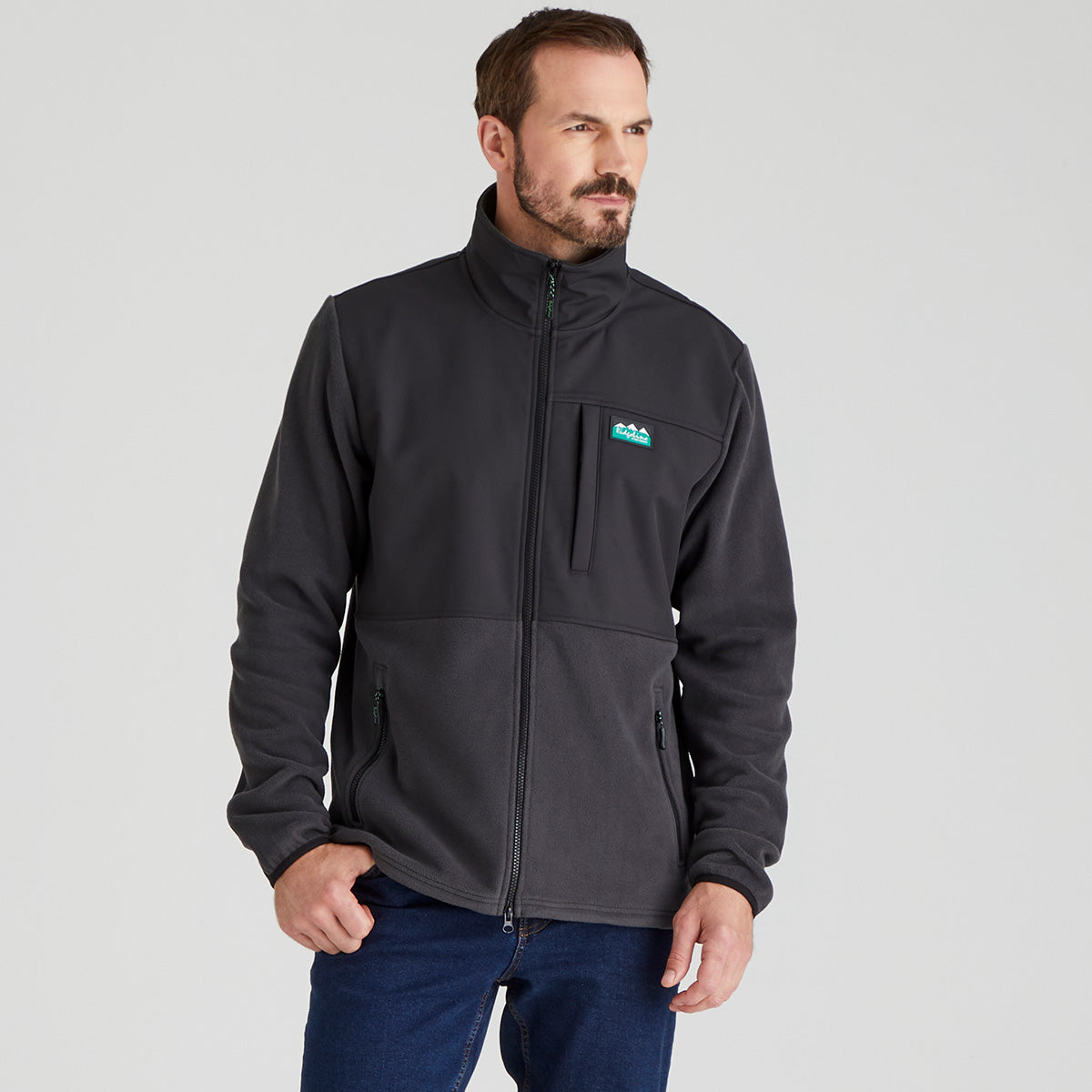 Man wearing a black Windproof jacket with a Ridgeline Clothing brand logo on a grey background