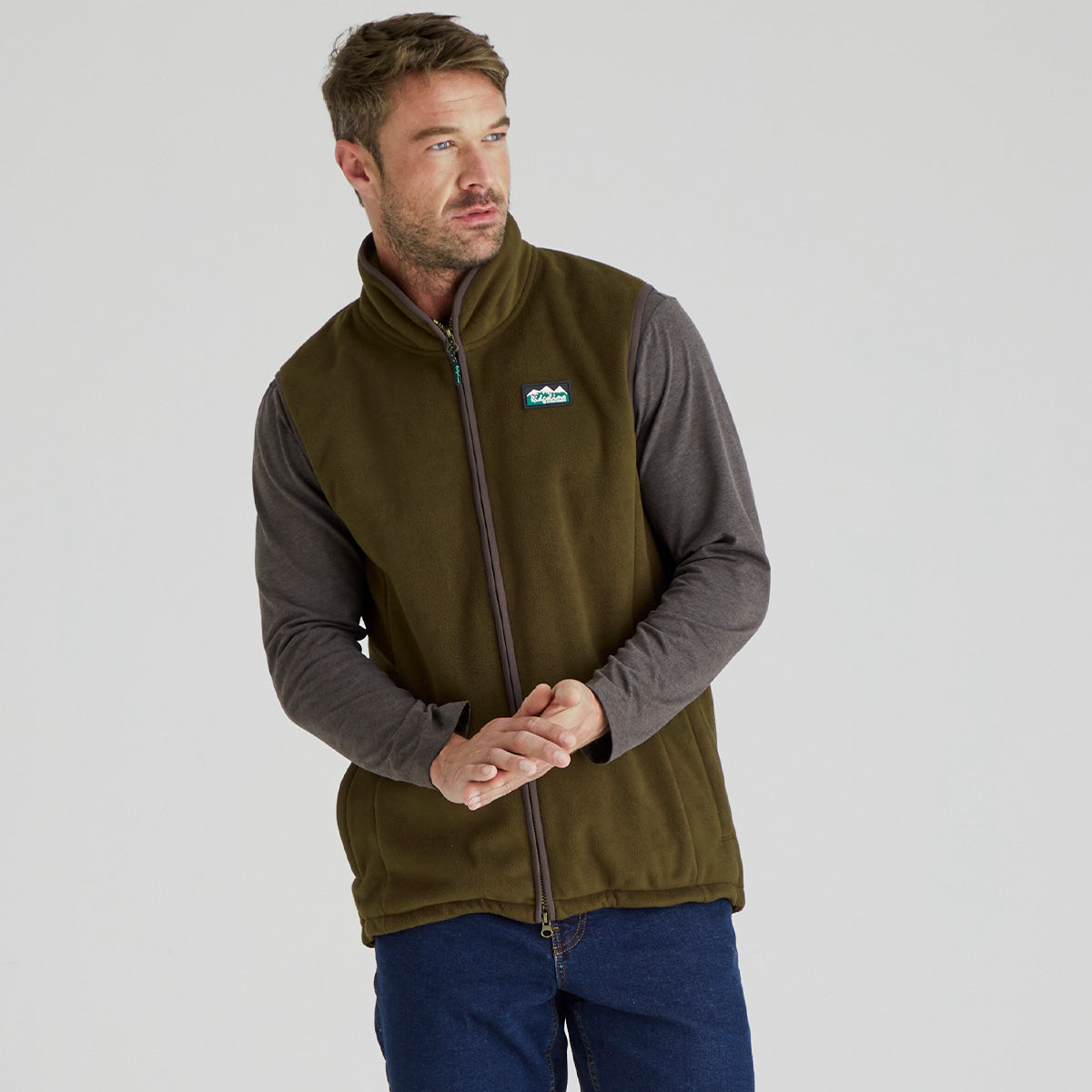 Man wearing brown windproof fleece gilet with jeans