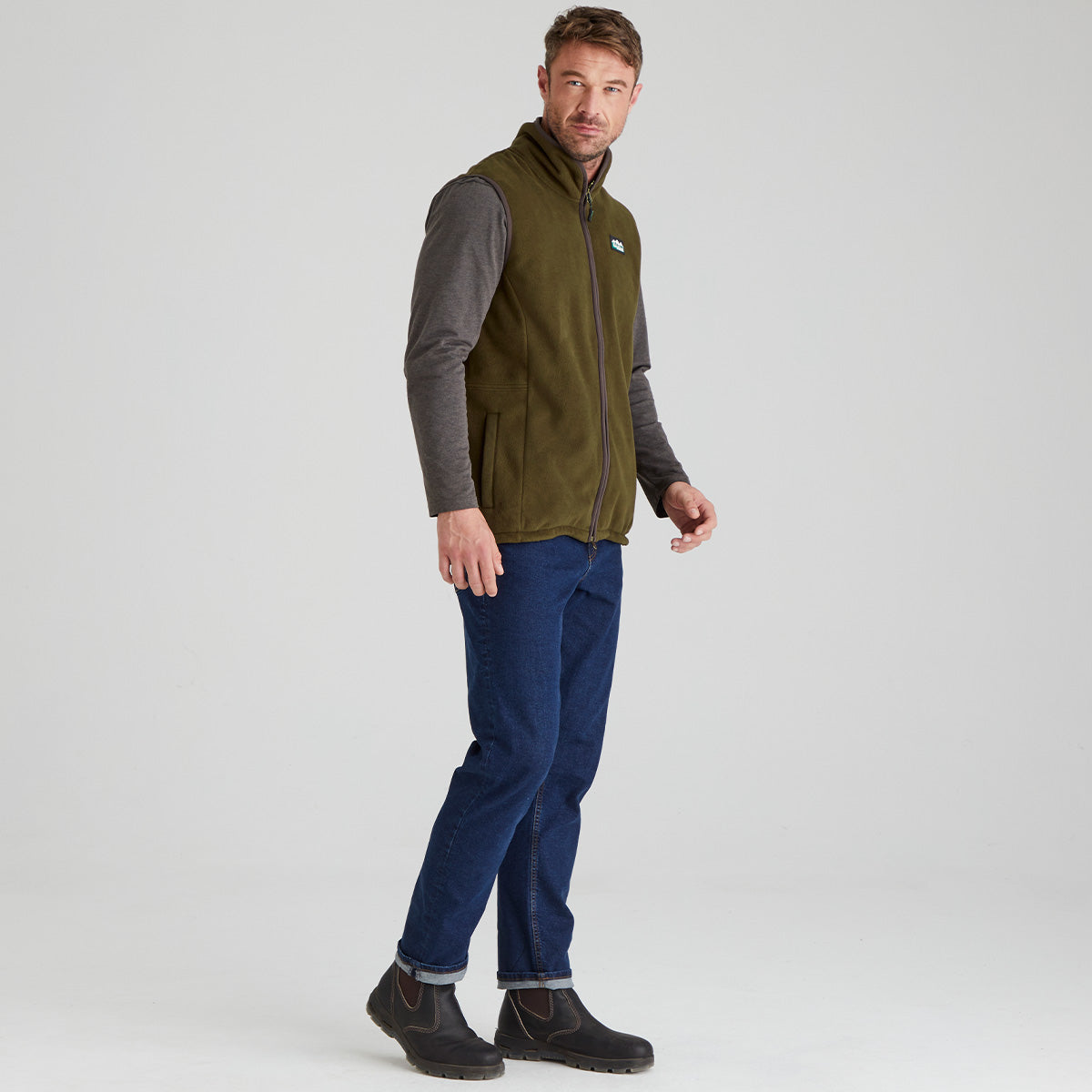 Man wearing brown Windproof fleece with jeans