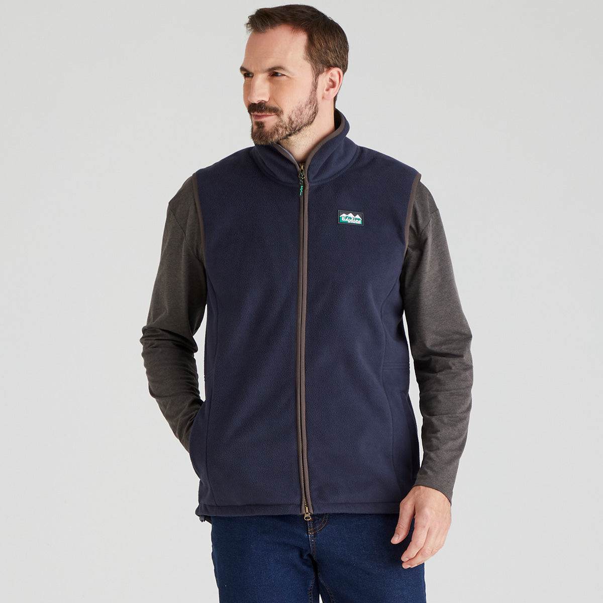 Man wearing blue windproof fleece gilet with jeans