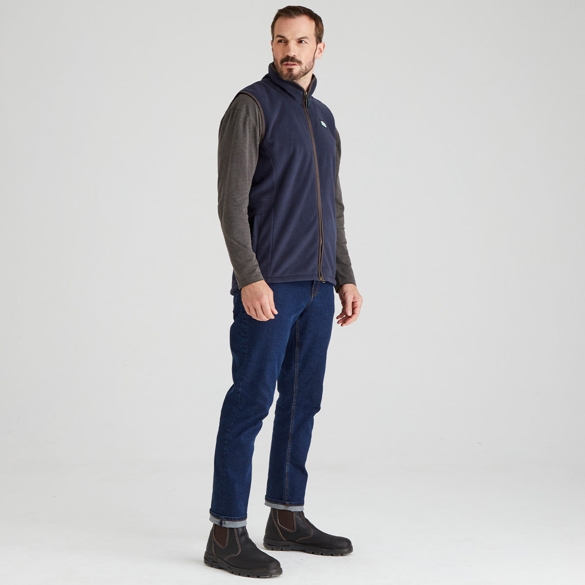 Man wearing blue windproof fleece gilet with jeans