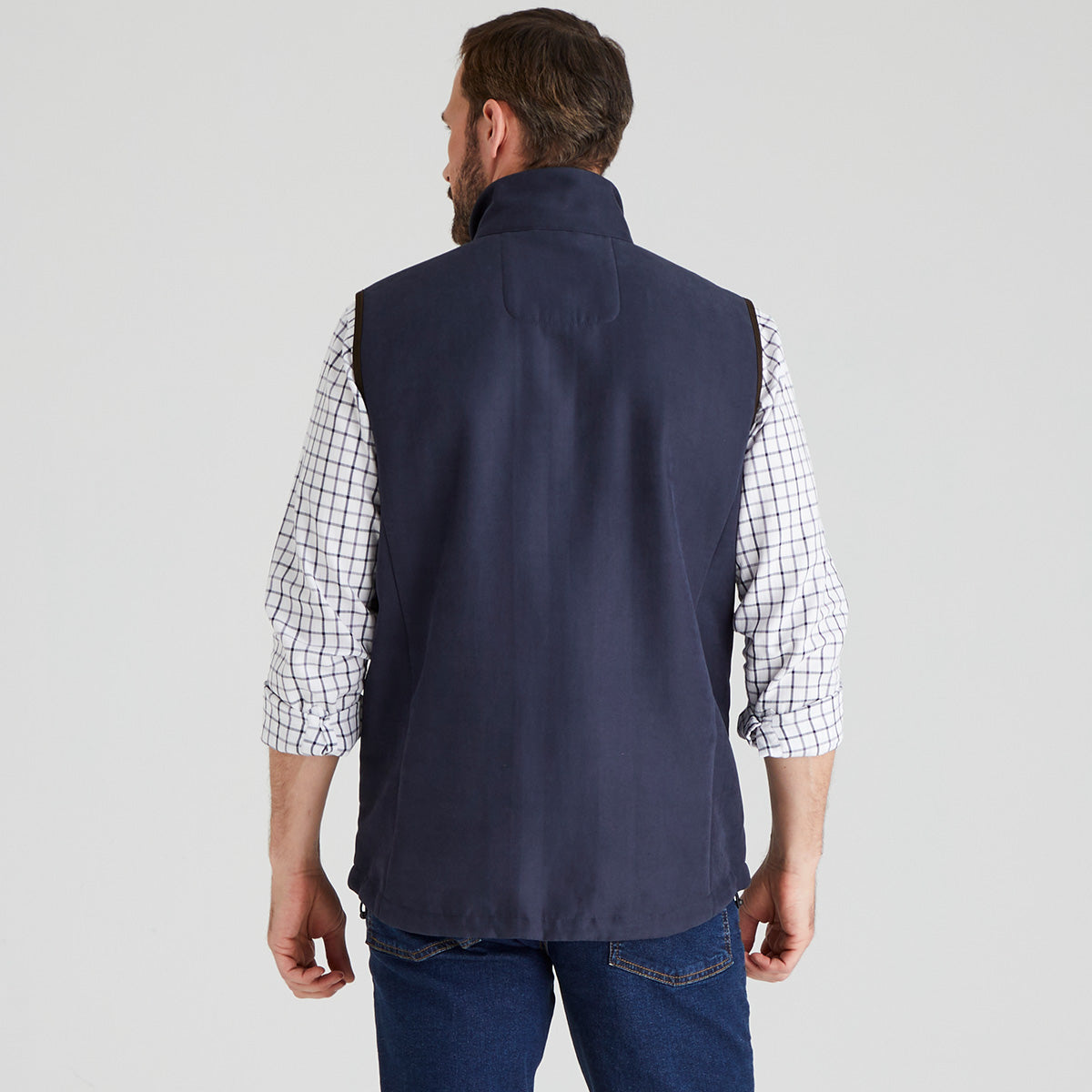 back view of Man wearing navy windproof fleece gilet with checked shirt