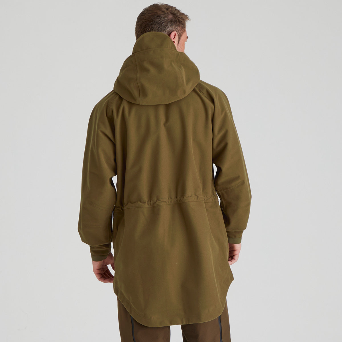 Person wearing a brown hooded coat on a white background