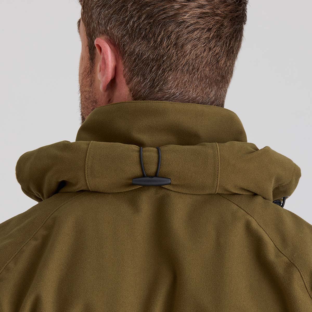 Brown jacket hood rolled up on a white background