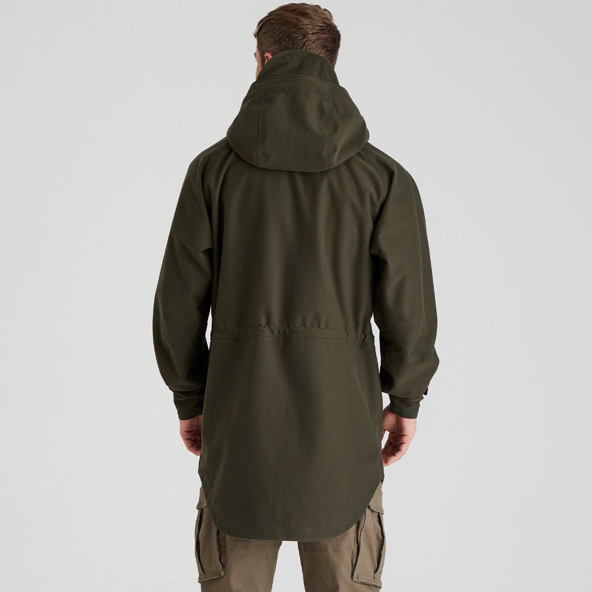 Back view of person wearing a green hooded jacket on a white background