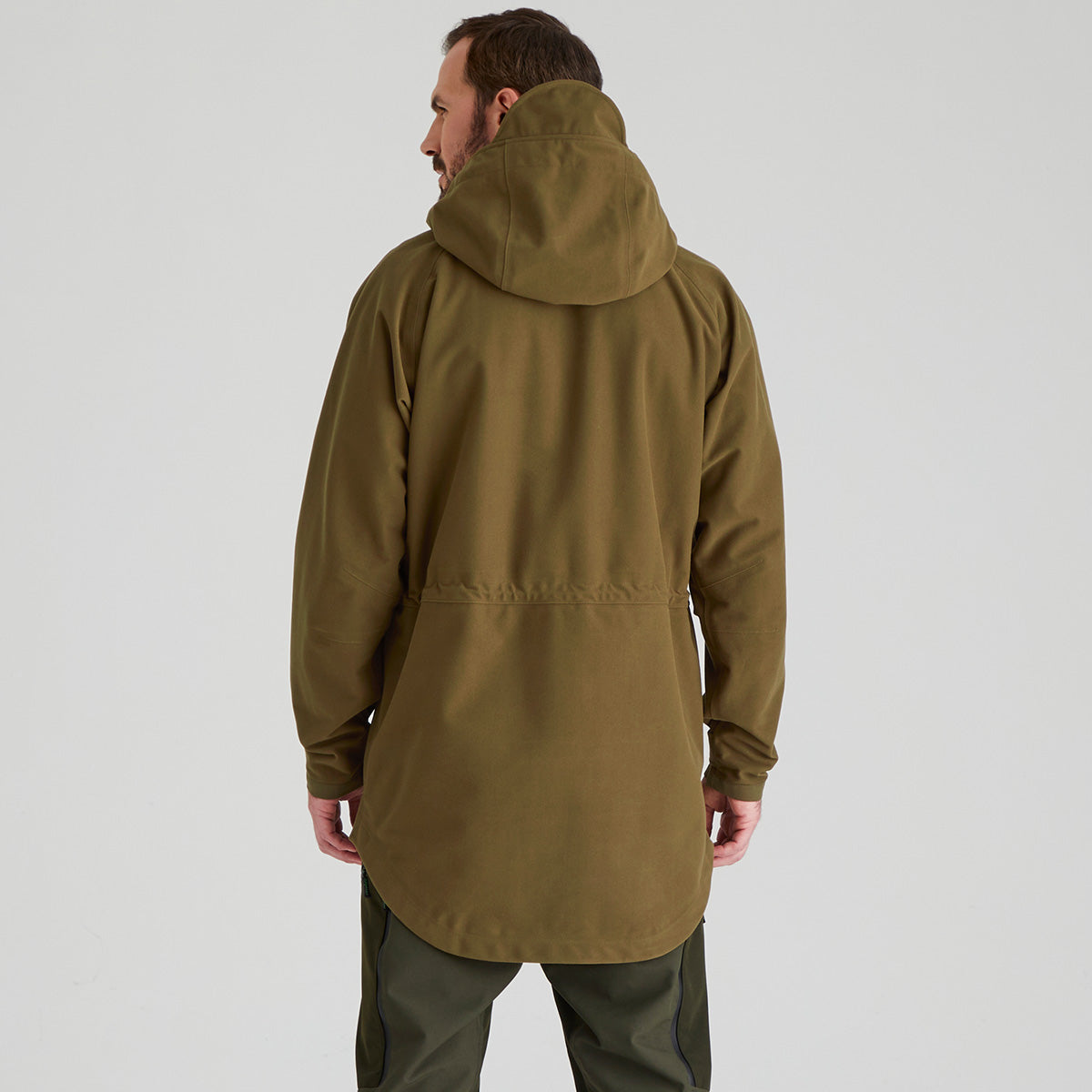 Person wearing a green hooded jacket on a white background