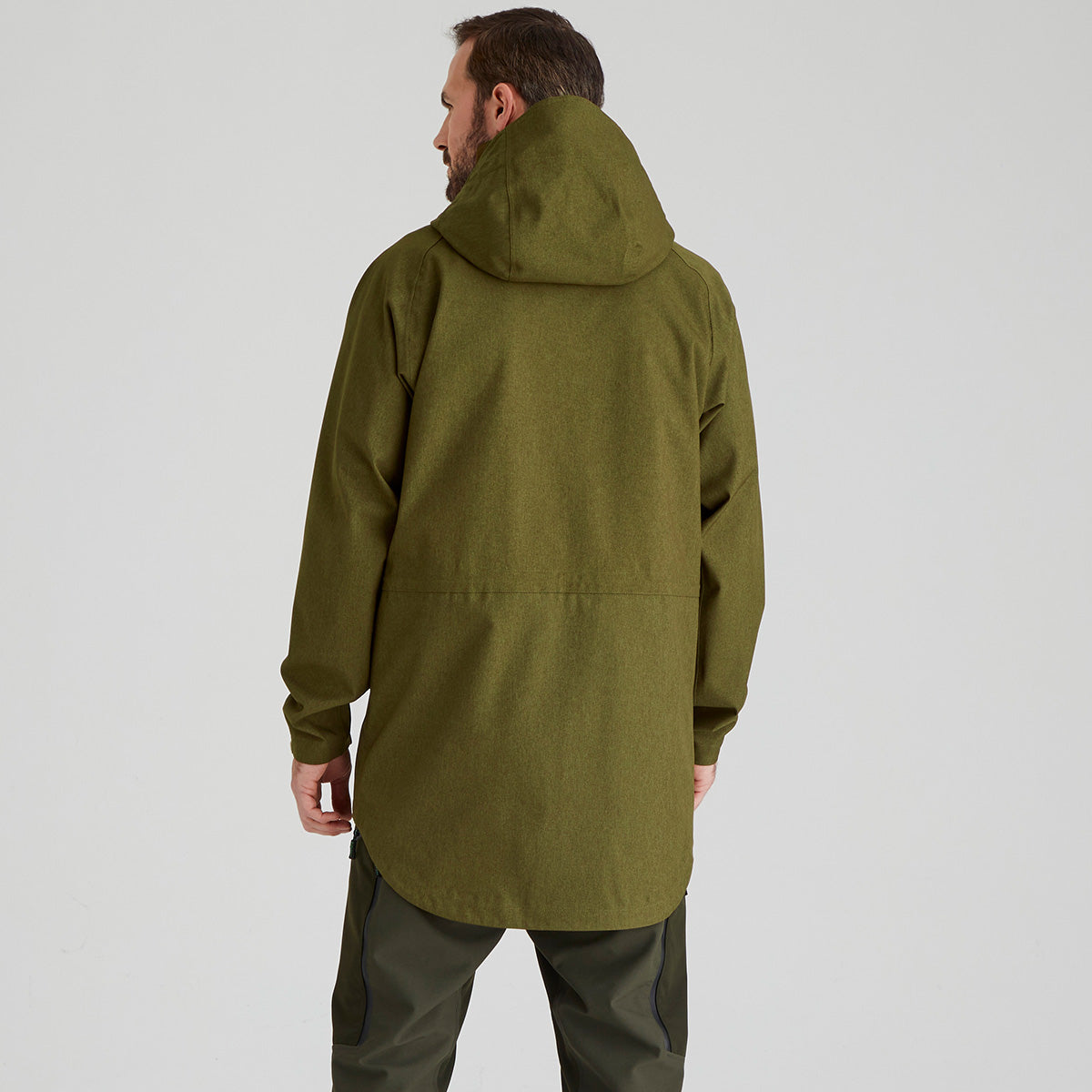 back view of person wearing a green hooded jacket on a light grey background