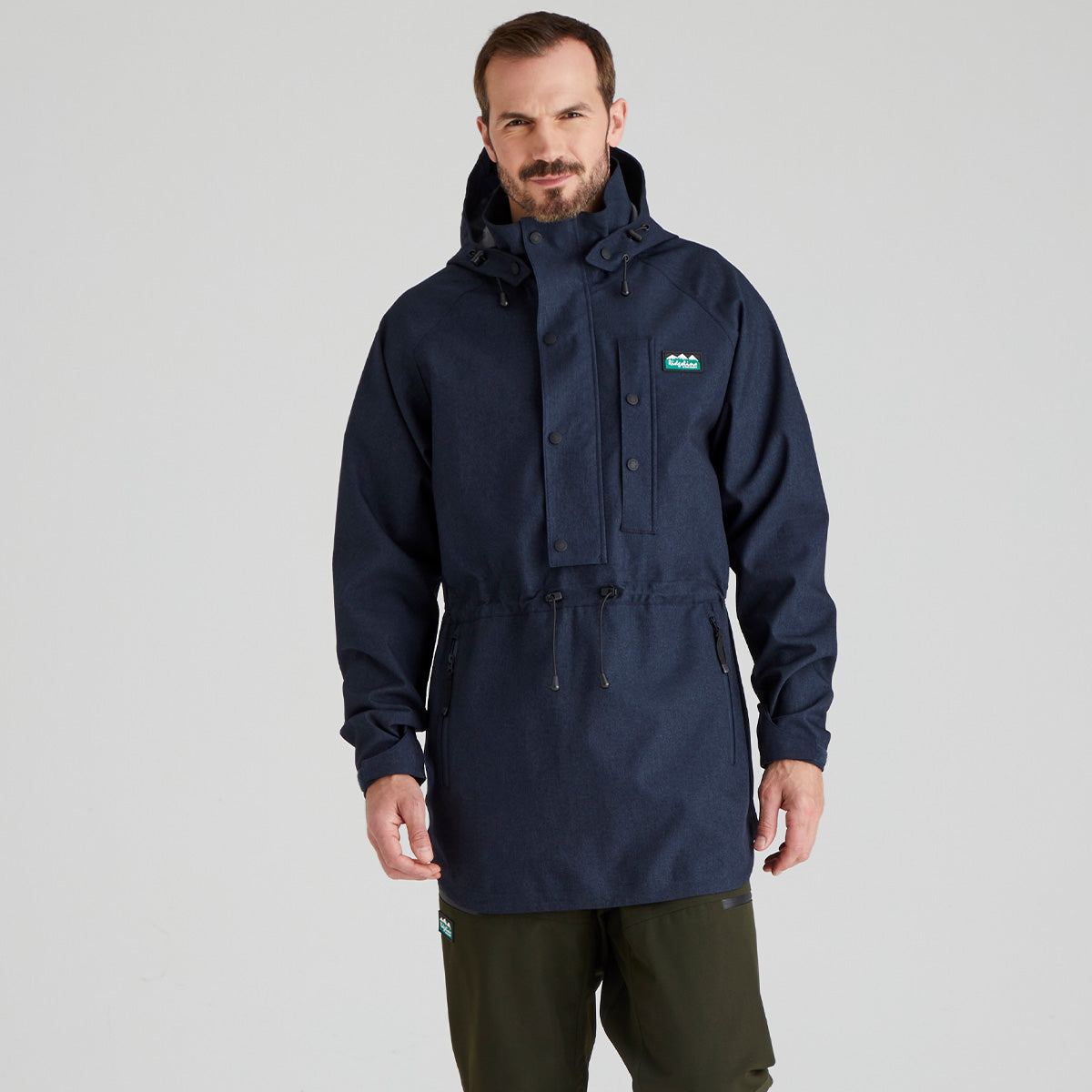 man wearing navy waterproof smock with ridgeline clothing logo