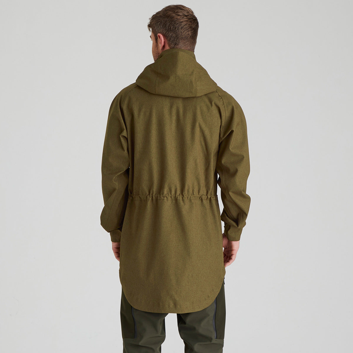 Back of person wearing a green raincoat on a plain background