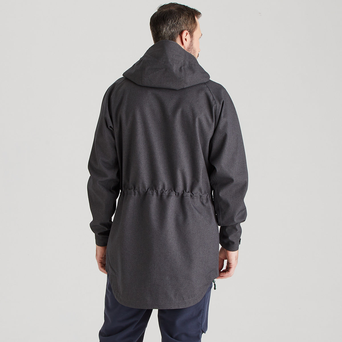 Man wearing a gray raincoat on a light gray background