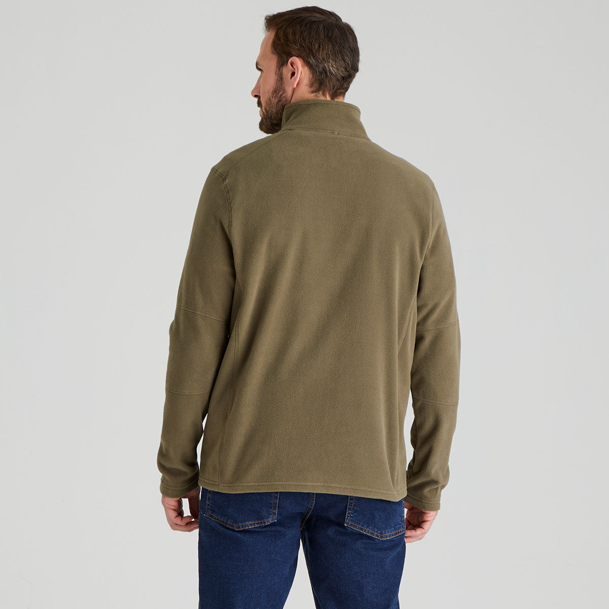 back view of man wearing a green fleece jacket and blue jeans on a white background