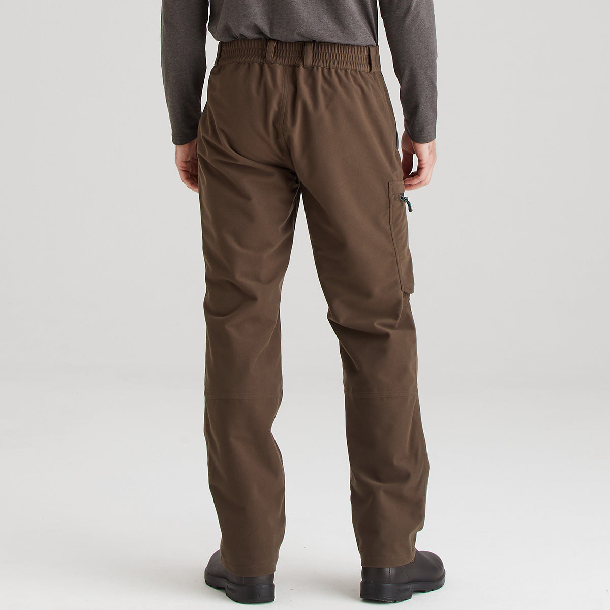 Brown pants worn by a person on a white background