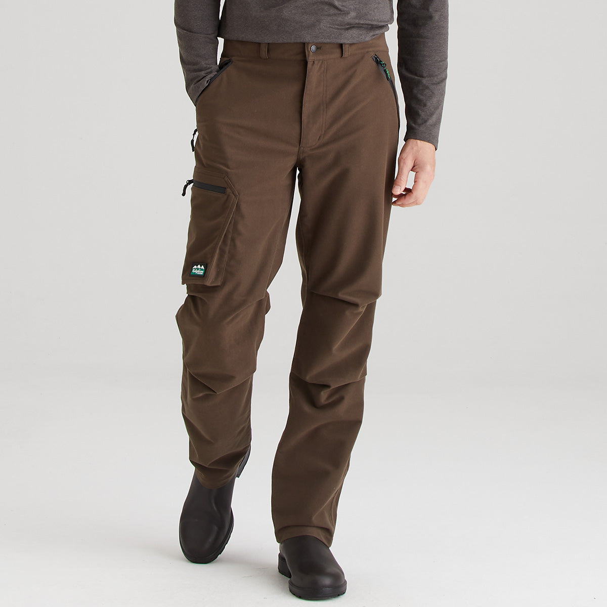 Brown pants worn by a person on a white background