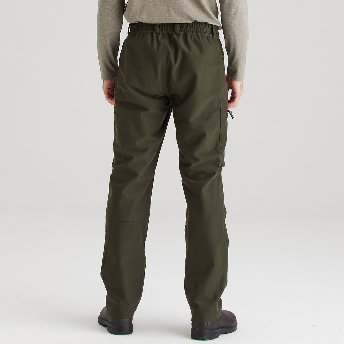 Person wearing olive green pants on a white background