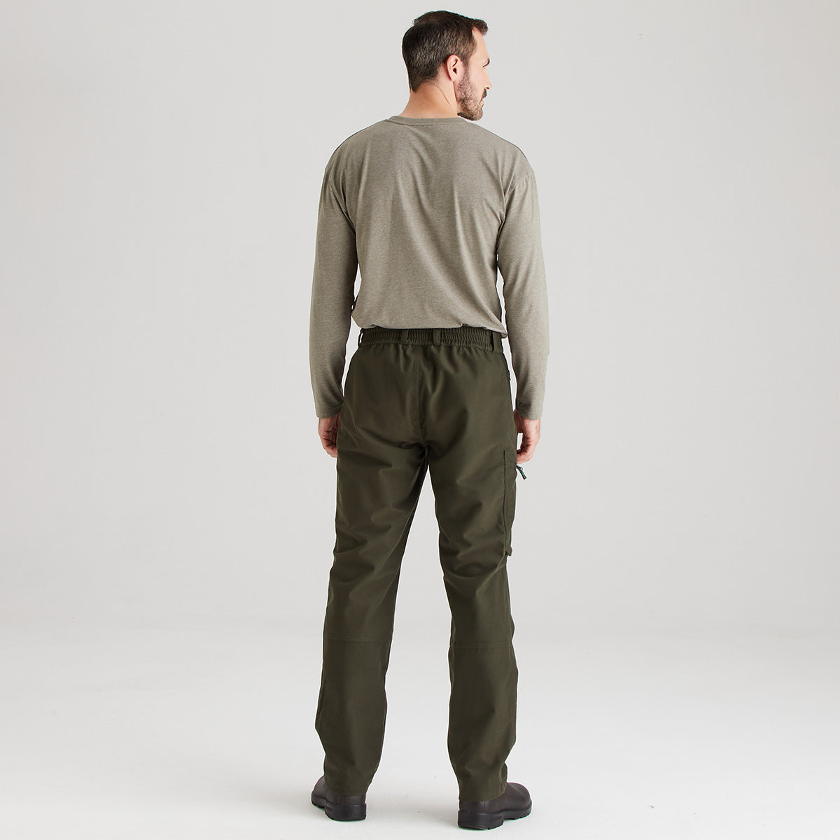 Man wearing a green long-sleeve shirt and green pants on a white background