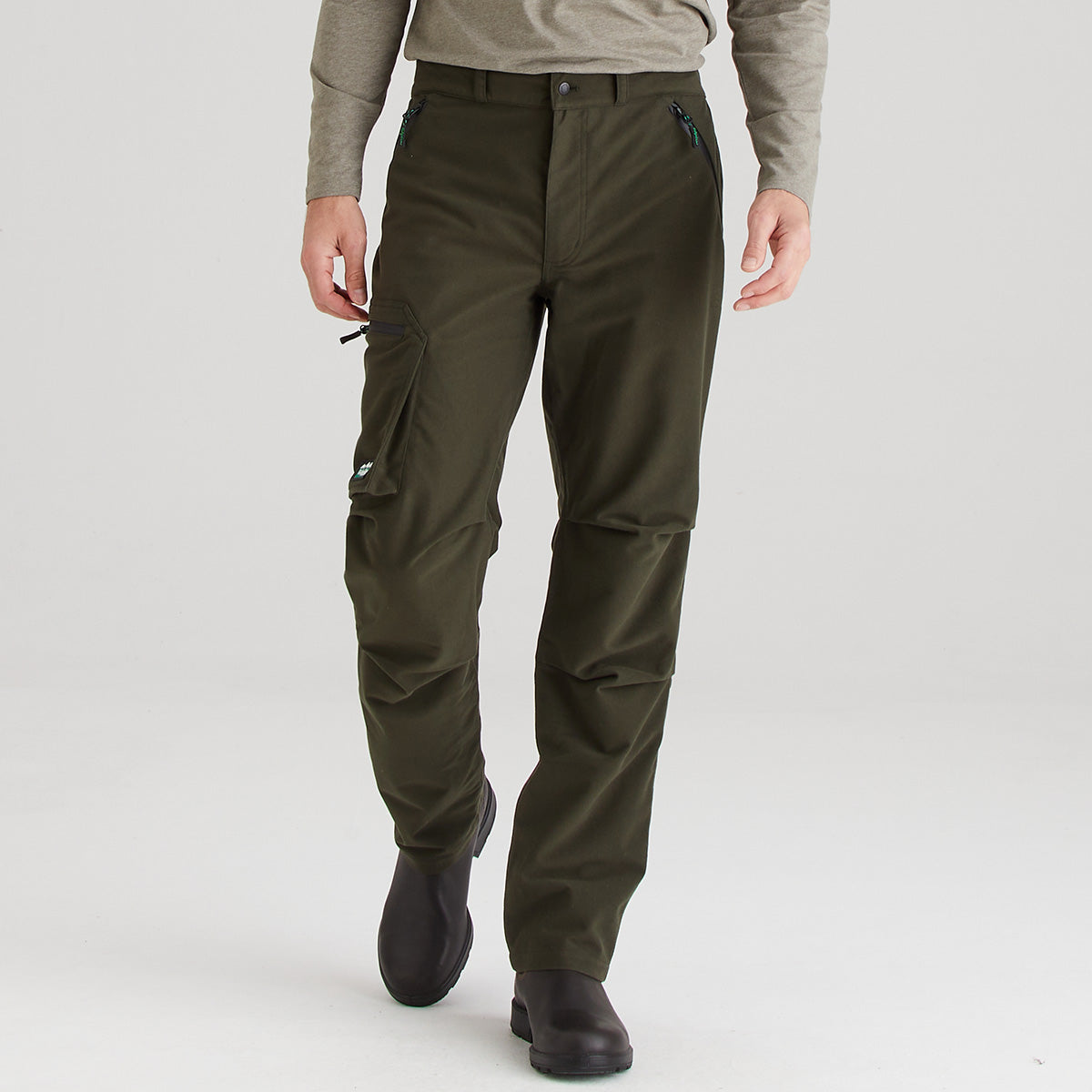 Person wearing olive green cargo pants on a white background