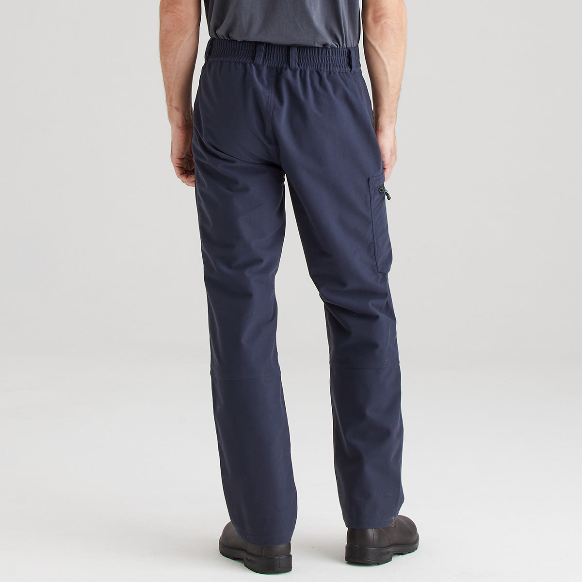 Navy blue pants worn by a person on a light gray background