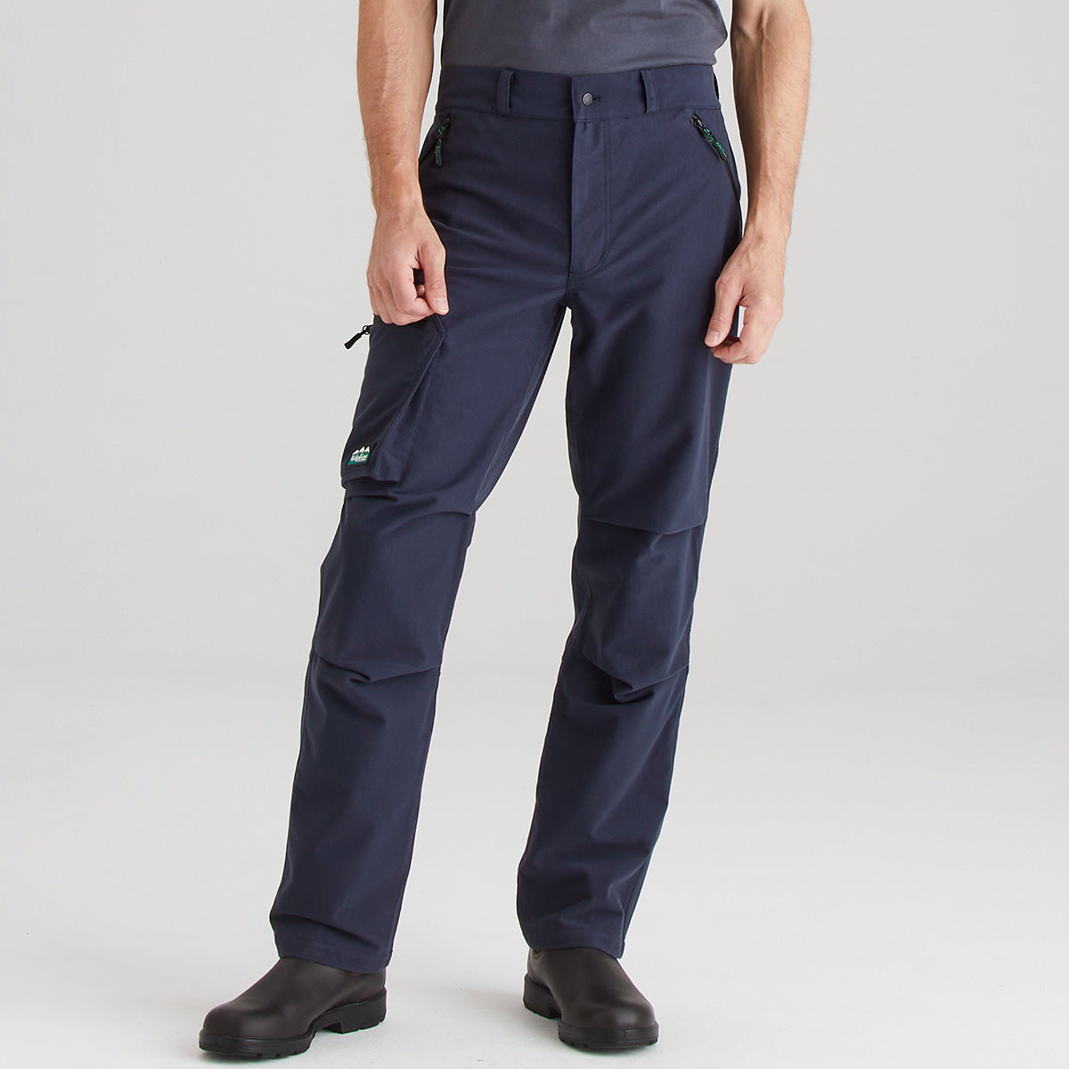 Navy blue pants worn by a person on a light gray background