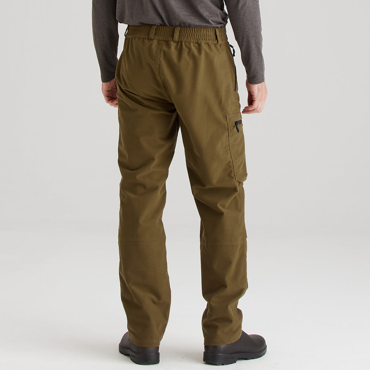 Brown cargo pants worn by a person on a white background