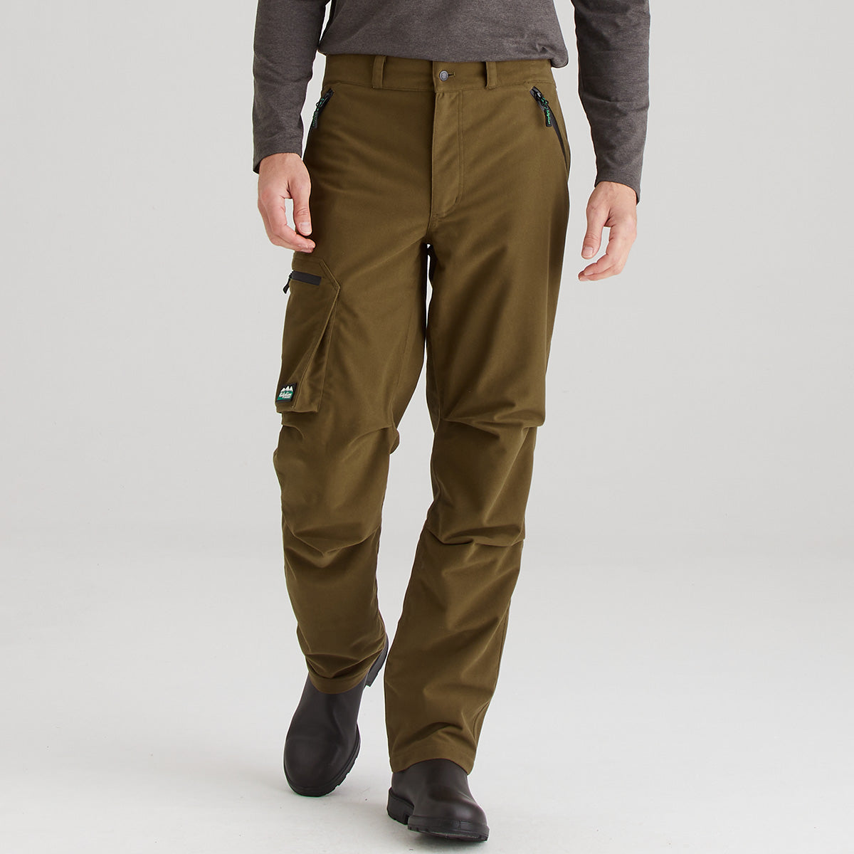 Brown cargo pants worn by a person on a light gray background