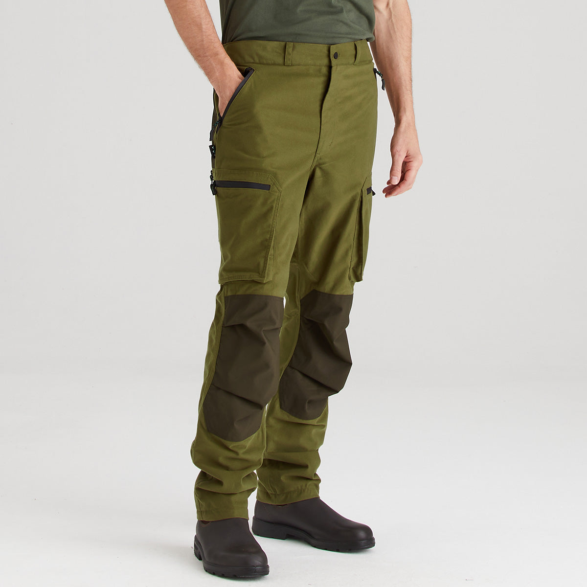 Person wearing green hiking pants on a white background