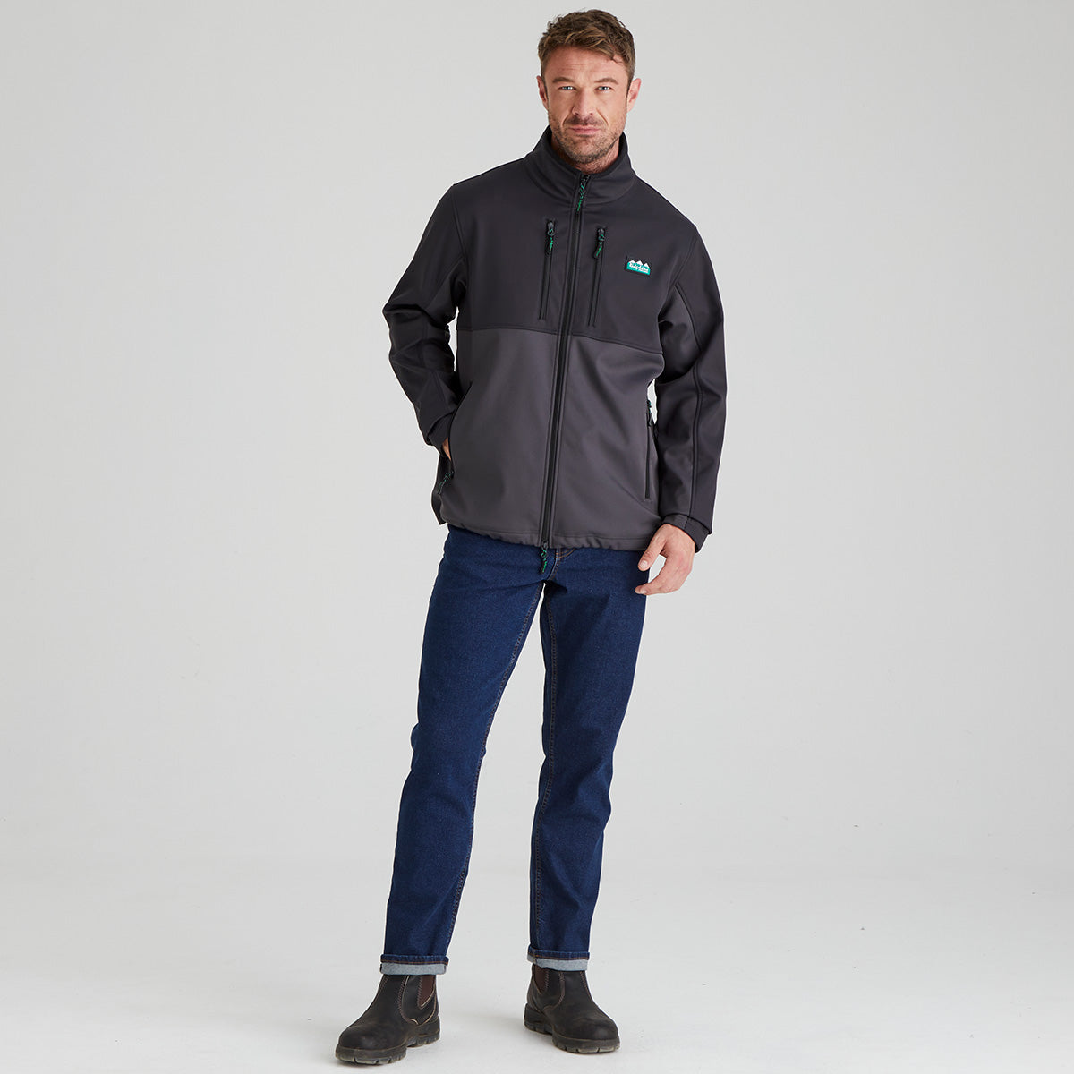 Man wearing a dark grey jacket with a Ridgeline Clothing logo on a light grey background