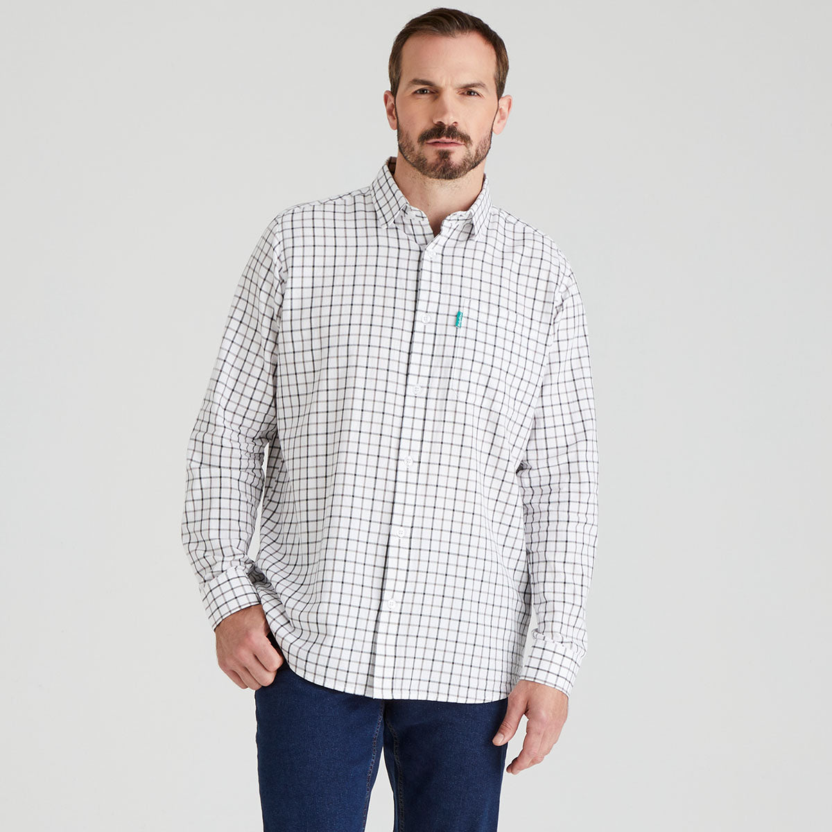 Man wearing a white checkered shirt with a brand logo on a grey background