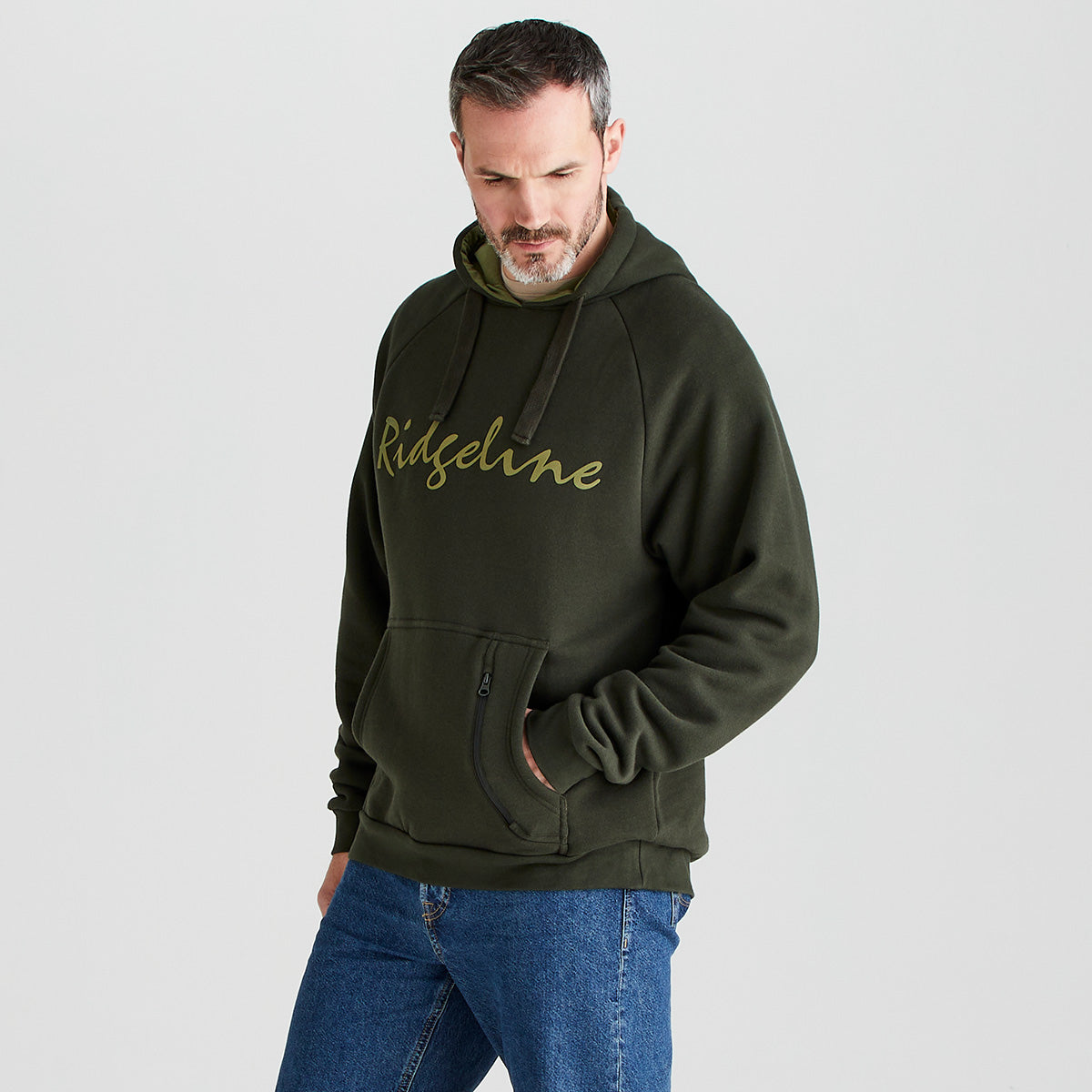 Man wearing a green hoodie with 'Ridgeline' logo on a light gray background