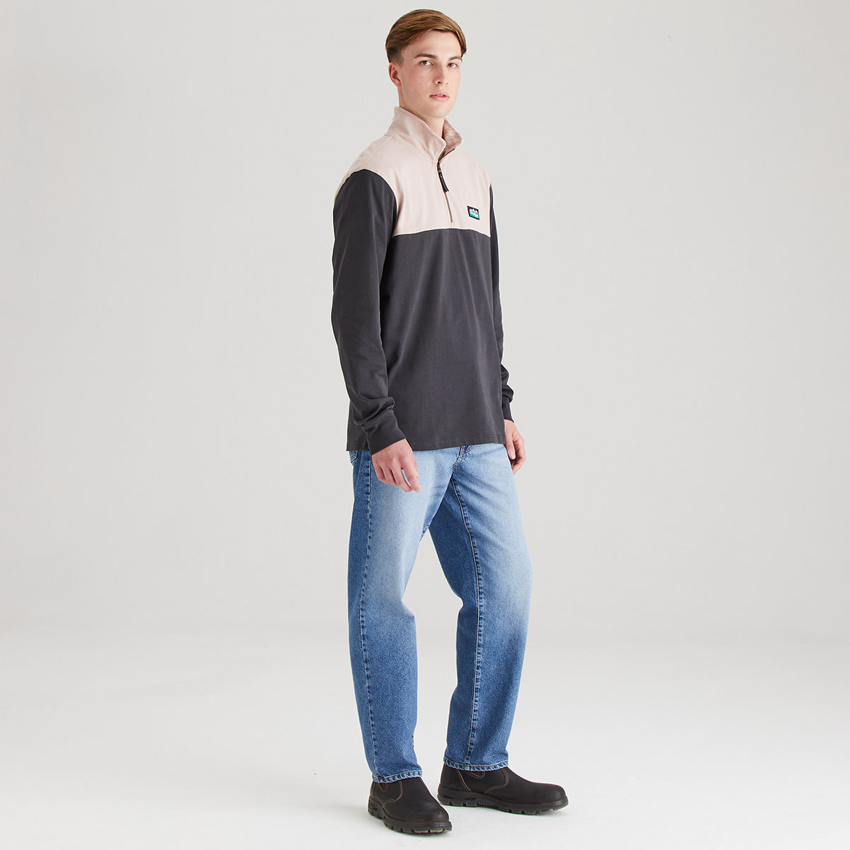 Man wearing two tone rugby shirt with grey background