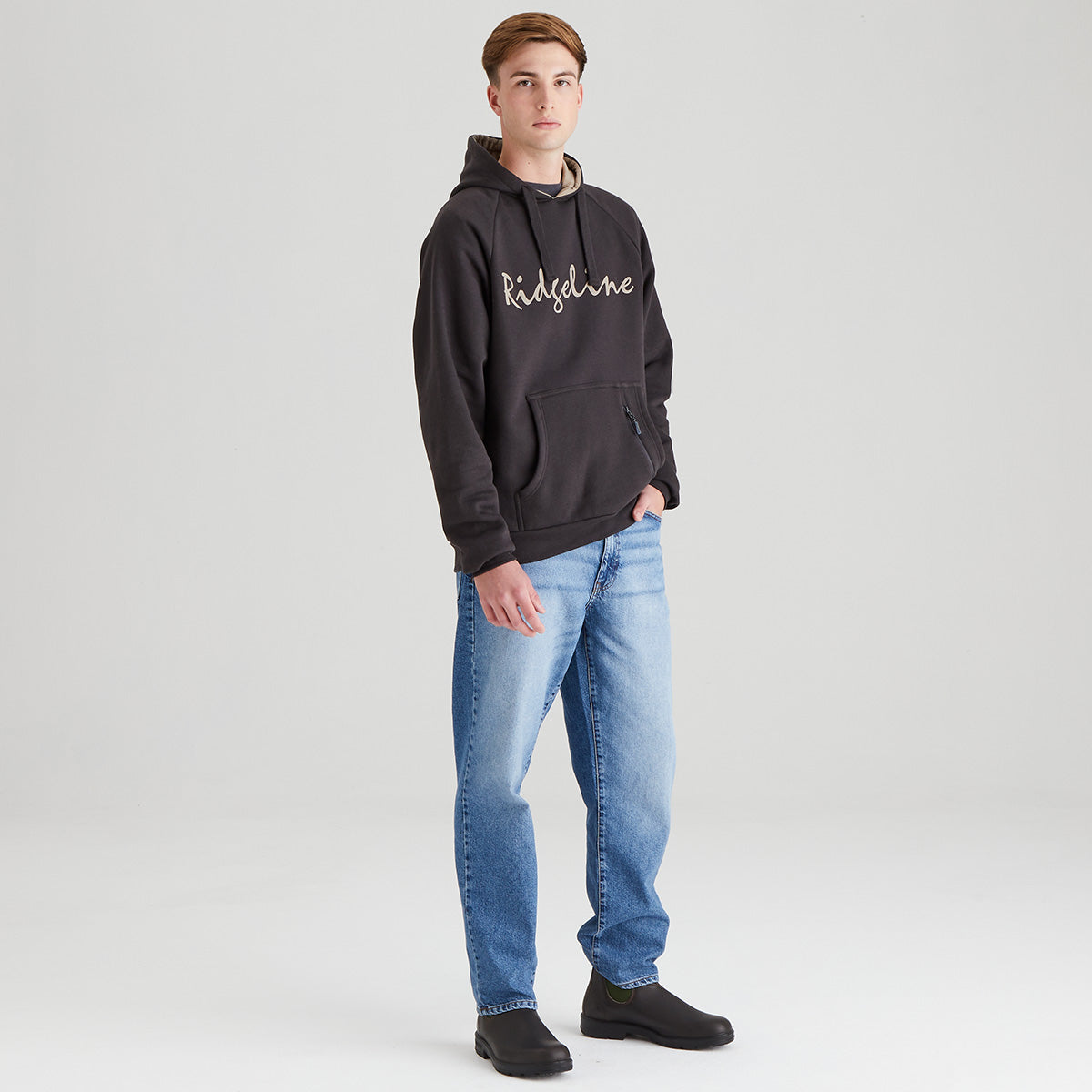 Grey/ black hoodie with 'Ridgeline' on the front, model wearing jeans