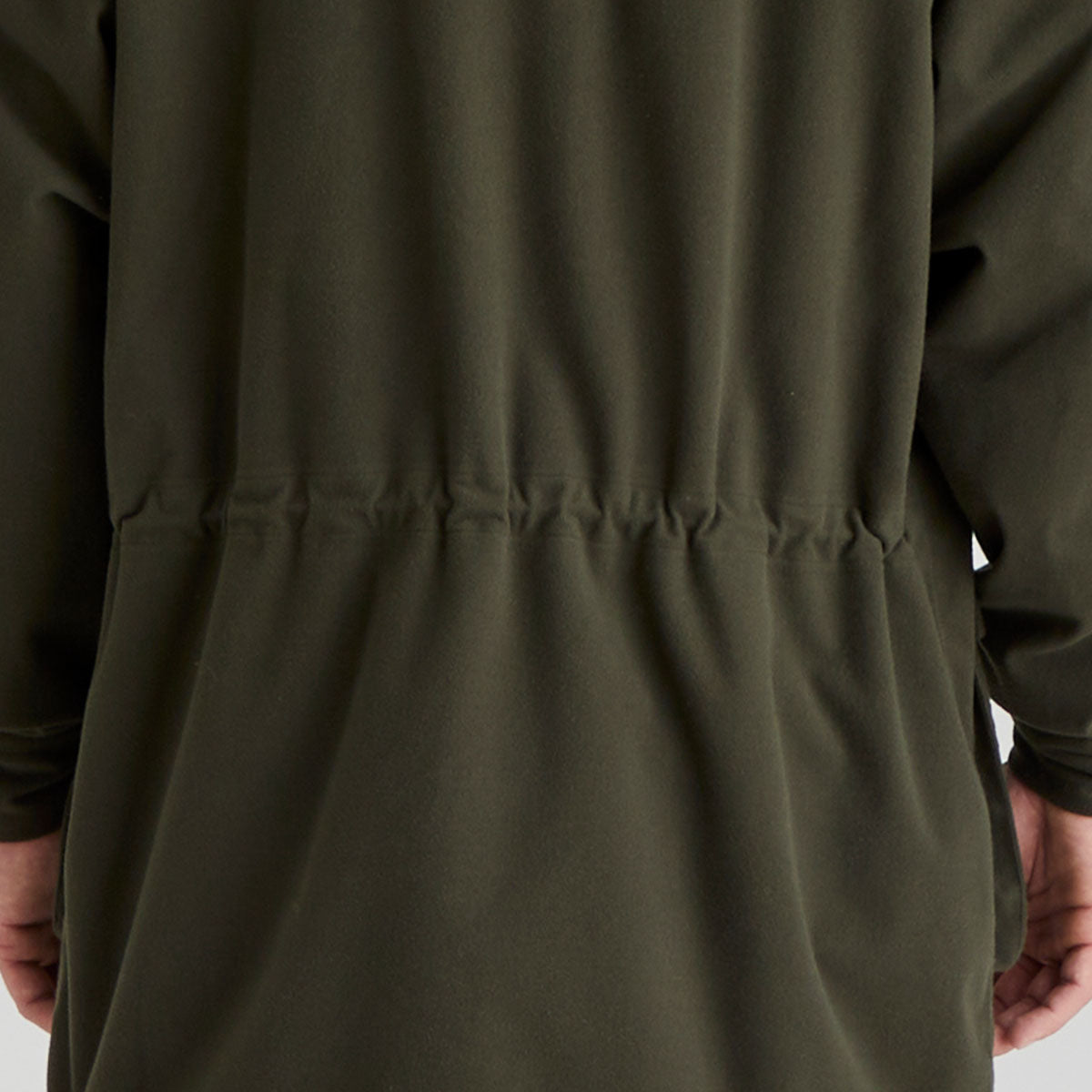 back view close-up of a green jacket with a focus on the waist area.