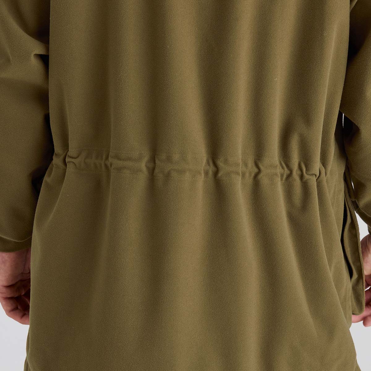 Close-up of a brown coat with a white background