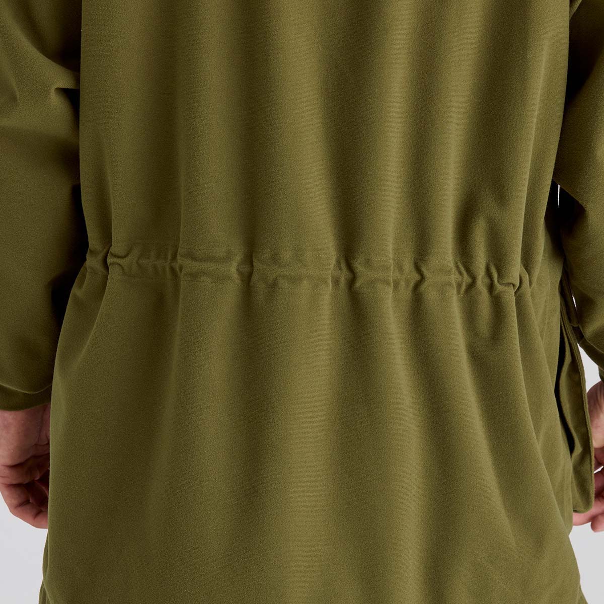 Close-up of a green coat with a white background