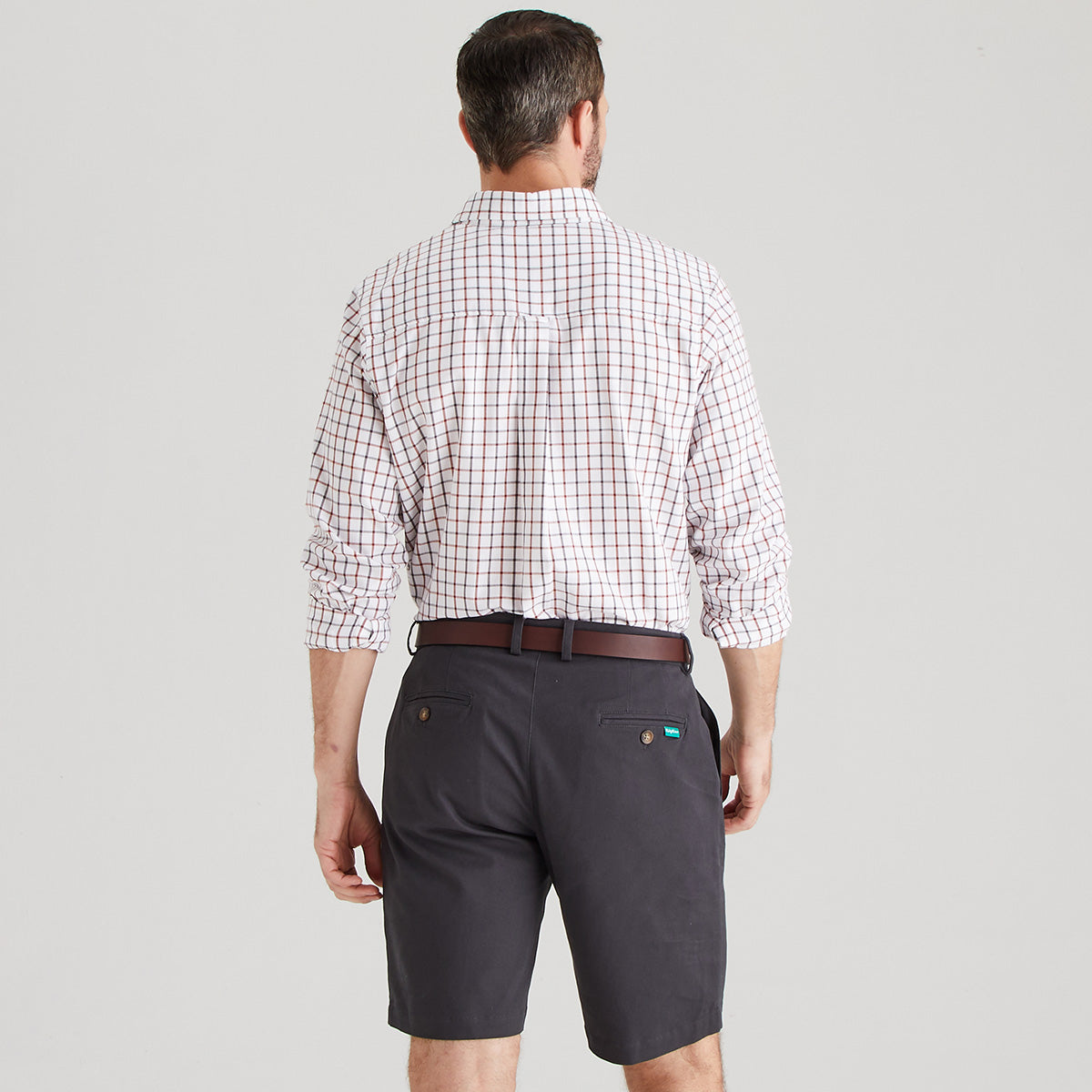 Back view of Man wearing shorts with checkered shirt
