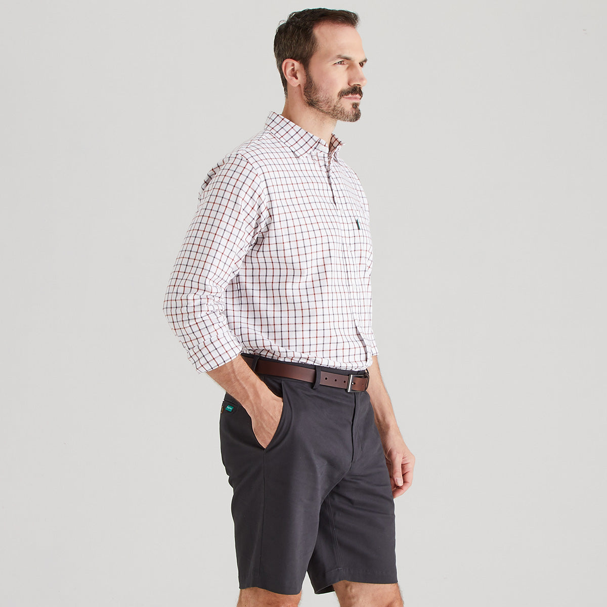 Side view of Man wearing shorts with checkered shirt