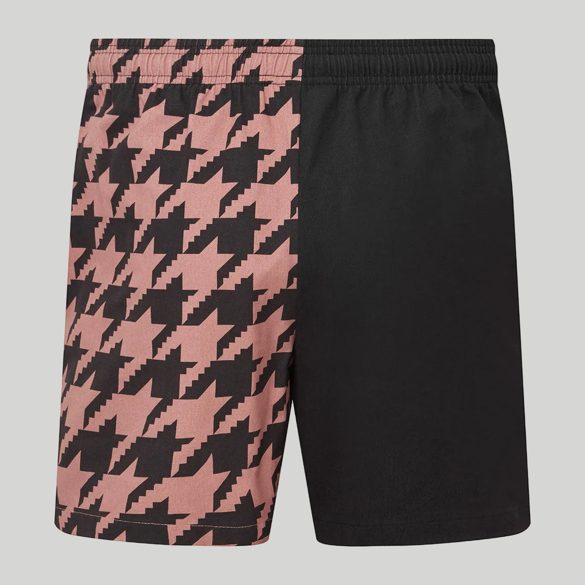 Black and pink houndstooth patterned shorts on a white background