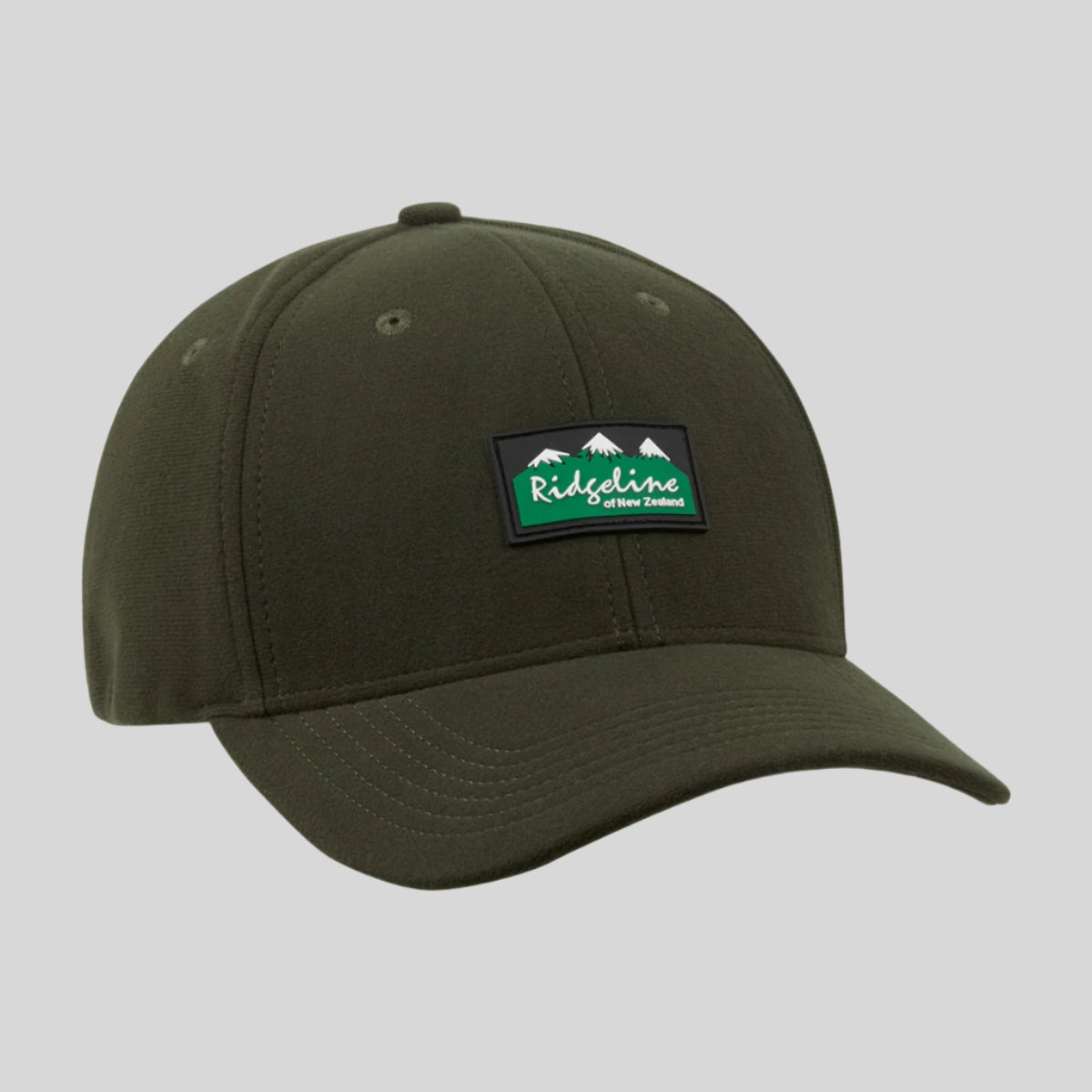 A green Monsoon Classic Cap with an adjustable back and a curved peak, featuring a Ridgeline Clothing logo patch on the front.
