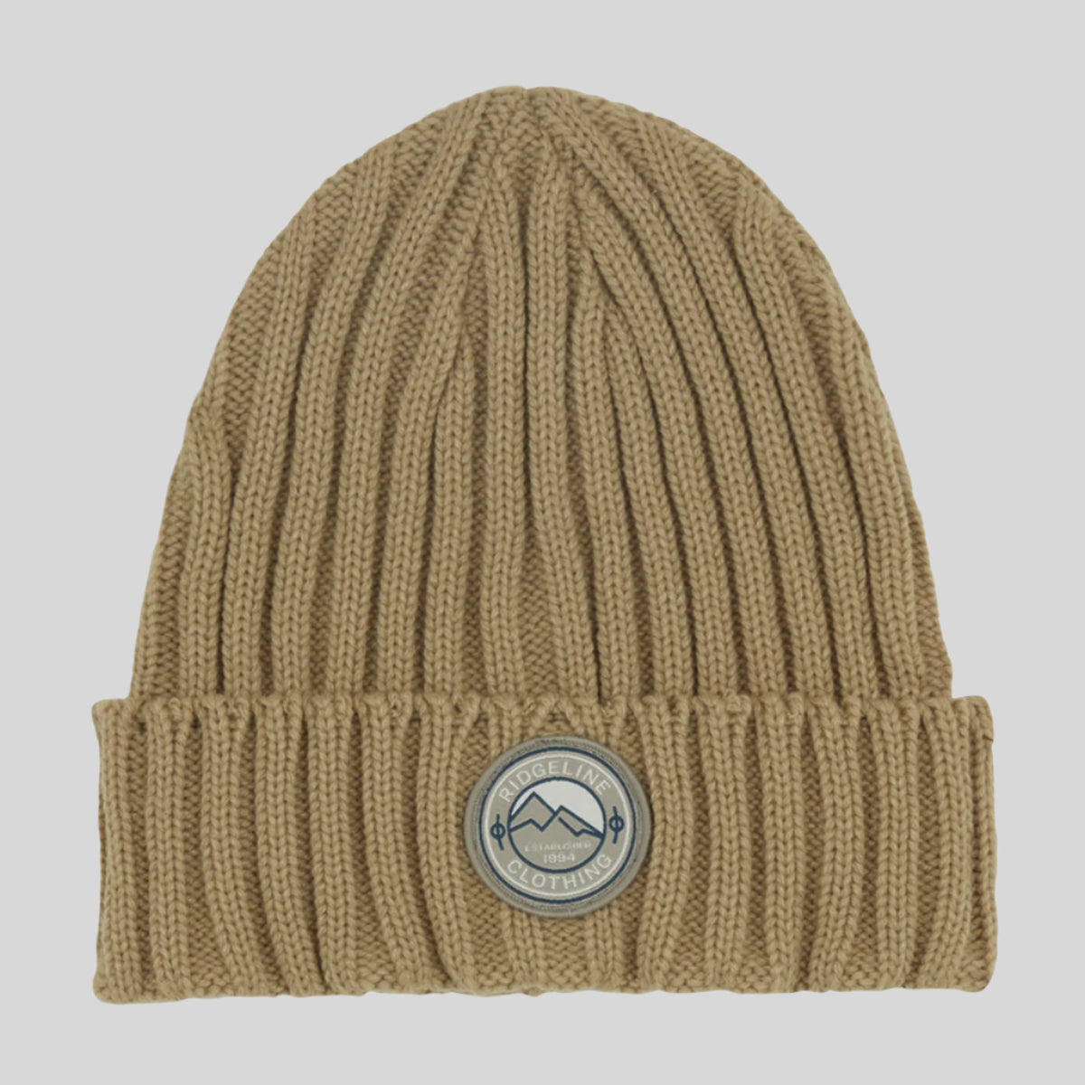 A beige knitted beanie with a wide rib turn-up and a logo patch on the front.