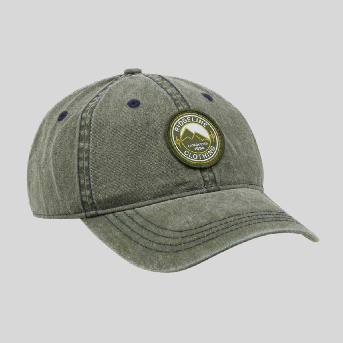 A green, relaxed fit ball cap with a front graphic and an adjustable back, featuring ventilation holes and a curved peak.