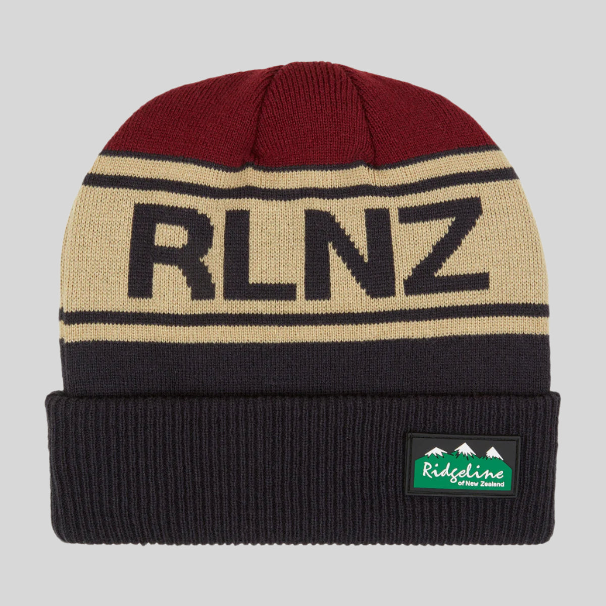 A knitted beanie with horizontal stripes in beige, navy, and red colours, featuring the text 'RLNZ' on the front.