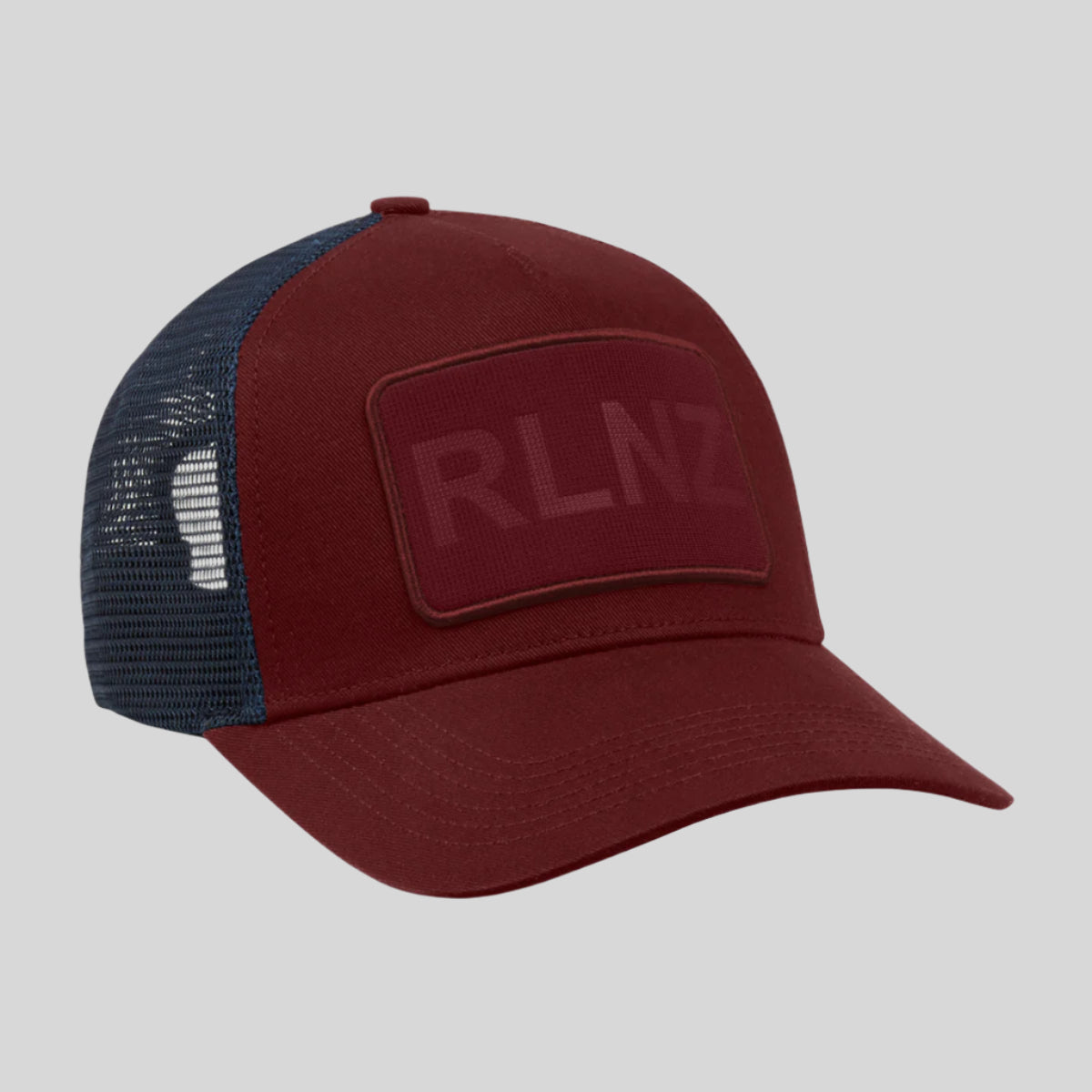 A red and blue trucker cap with 'RLNZ' text on the front.