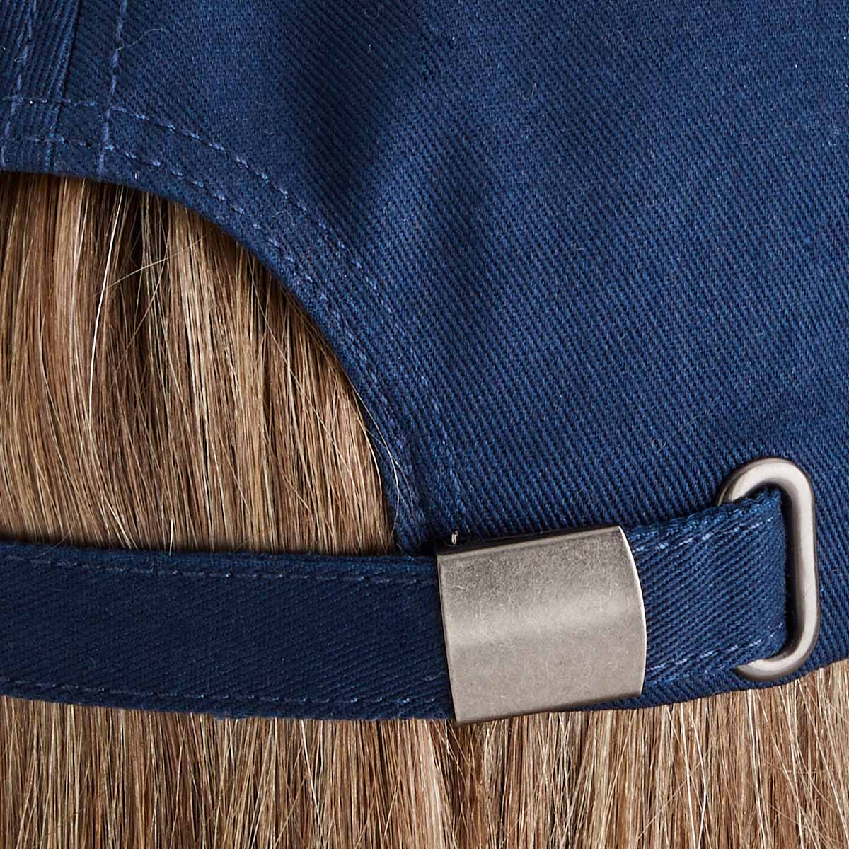 Close-up of a blue cap with a metal buckle and strap
