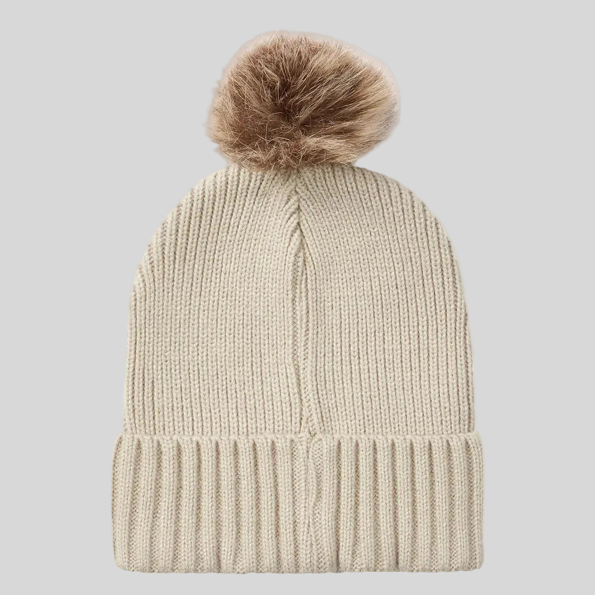 Cream ribbed knit beanie hat with faux fur pom pom, back view.